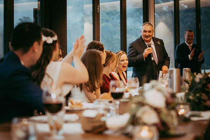 Guests at a wedding reception laughing